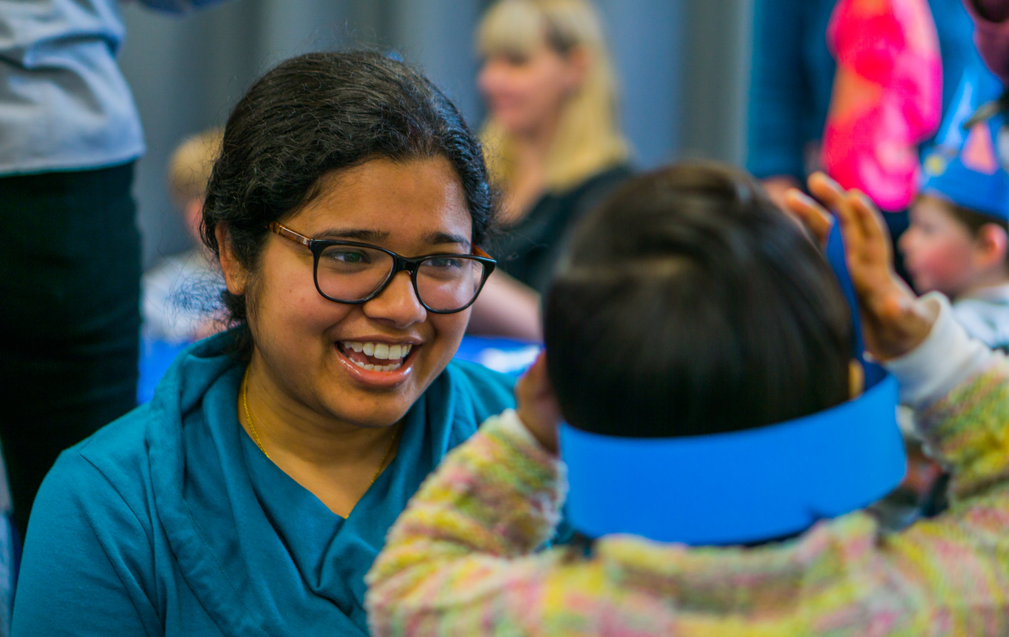 Woman smiling at a child at family library event