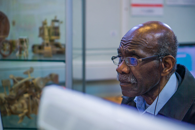 Black pensioner using a library computer
