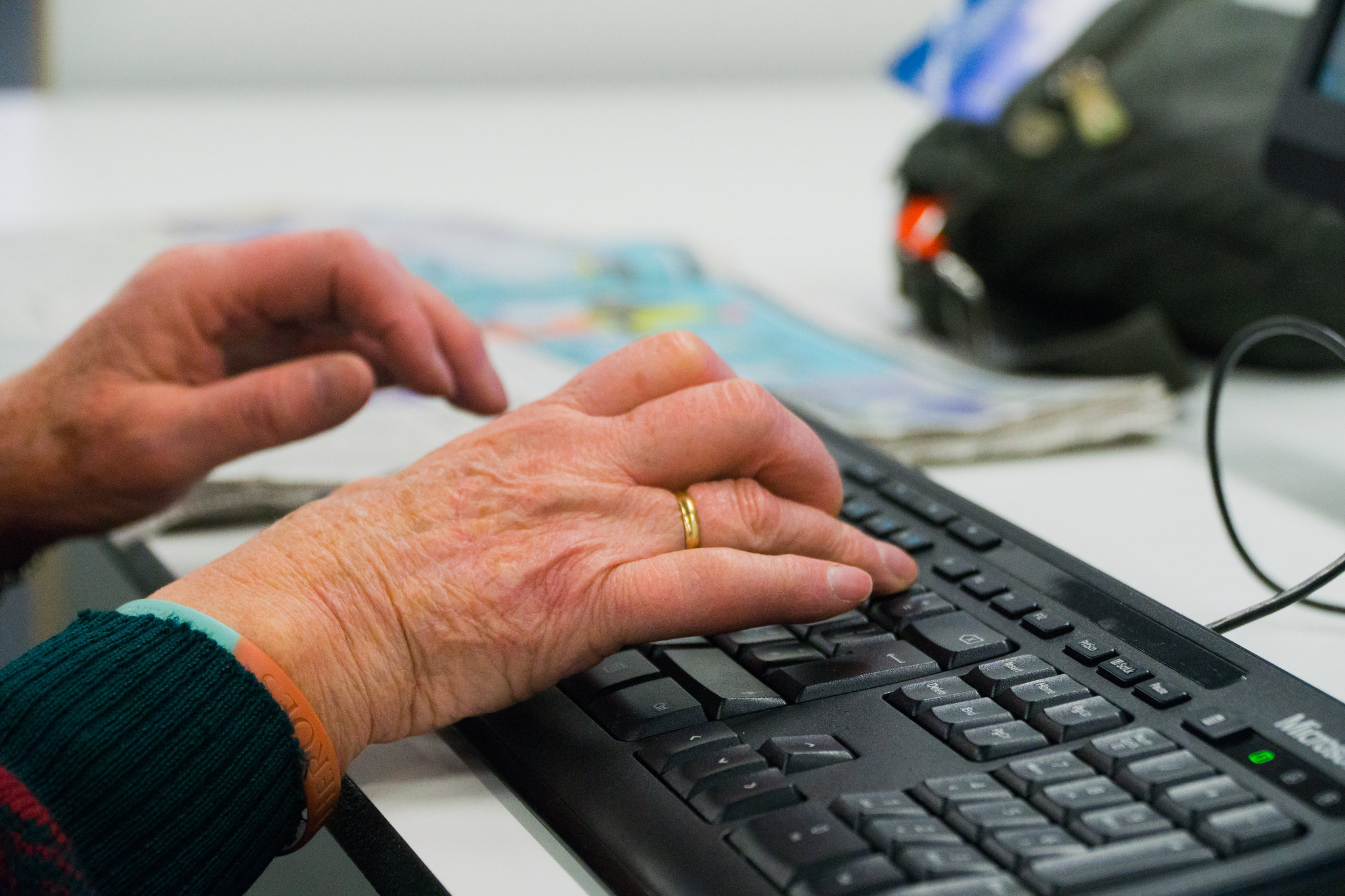 Elderly woman's hands on a keyboard