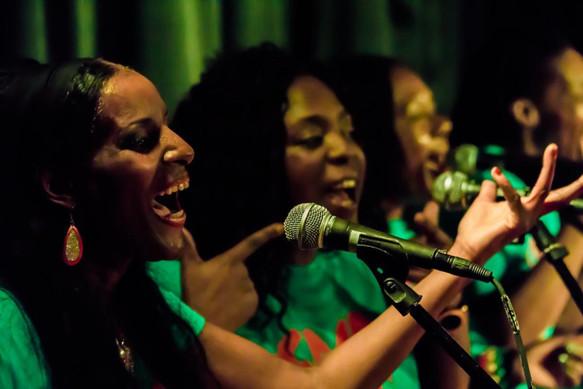 Reggae choir singing in a library