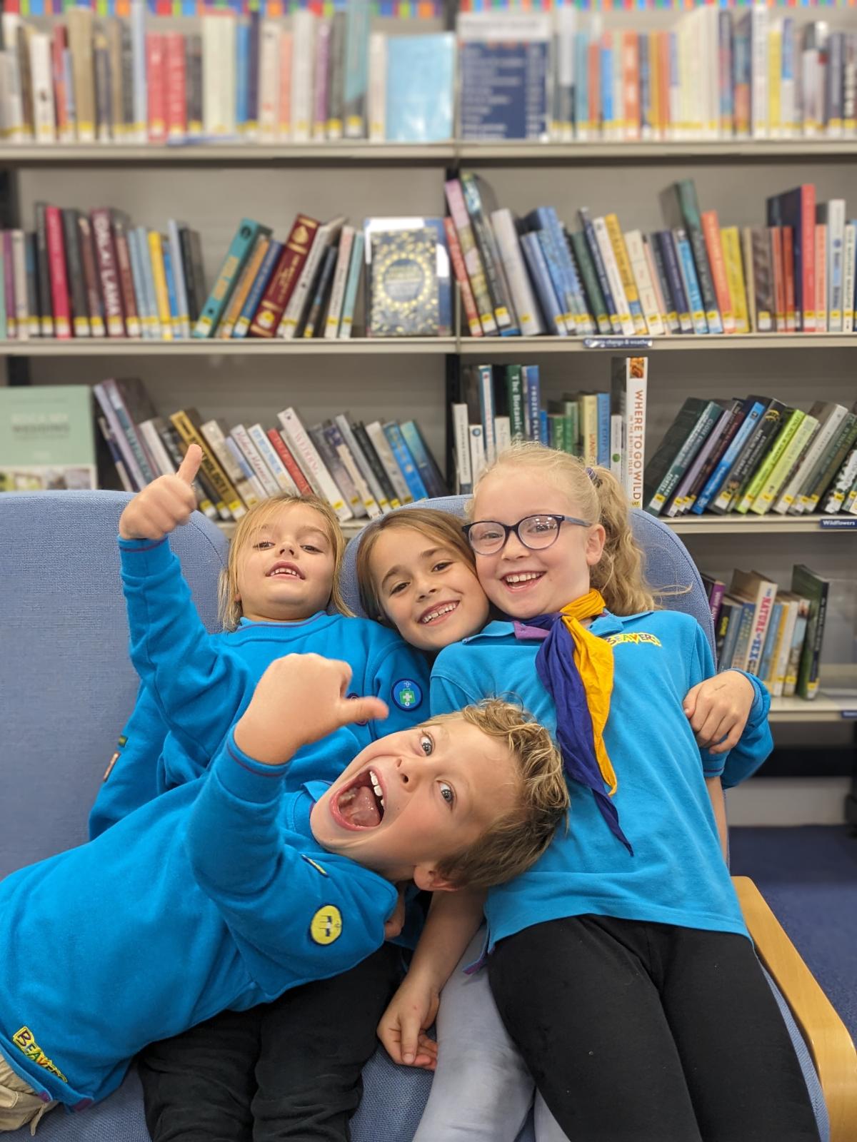 Children enjoy a tour of Godalming library. They are dressed in Scouts and Beavers uniforms.