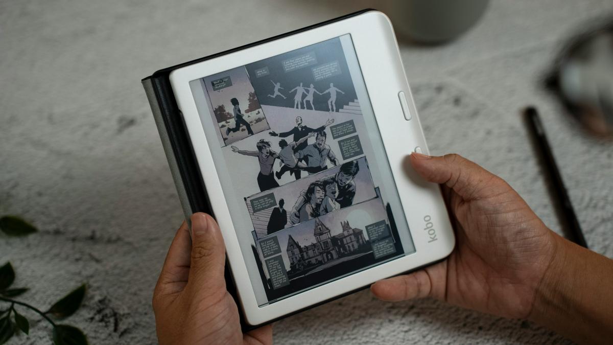 Person holding an ereader displaying a graphic novel page
