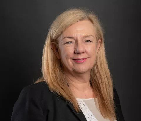 A portrait photograph of Kathryn Harrison who is smiling into the camera.