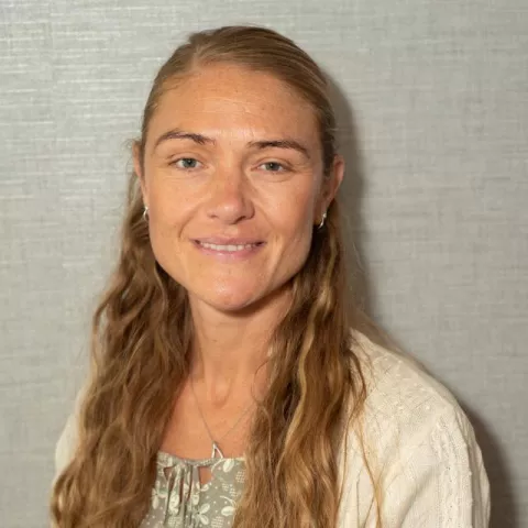 Tessa Blades is seen smiling into the camera.