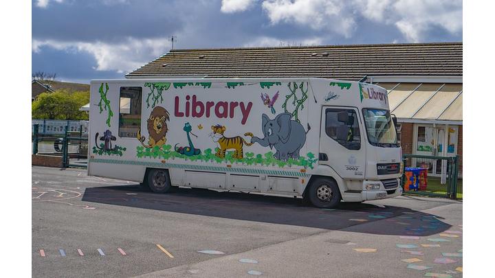 A mobile library vehicle decorated with cartoon animals