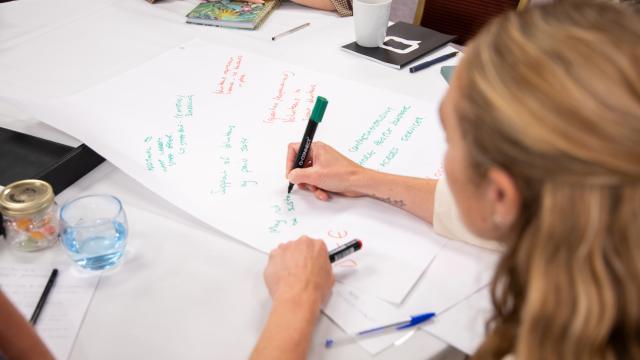 Photo of someone writing on a flip chart