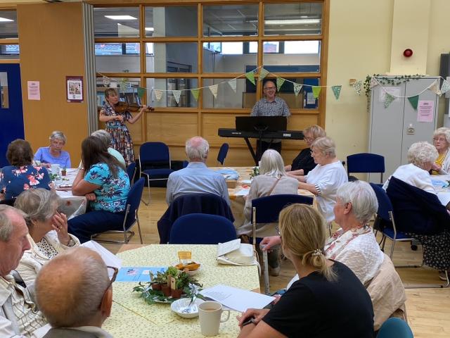 A Know Your Neighbourhood group meets indoors at Barnsley for a garden party.