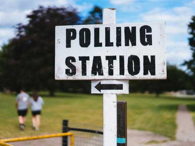 Polling Station sign with an arrow pointing left.