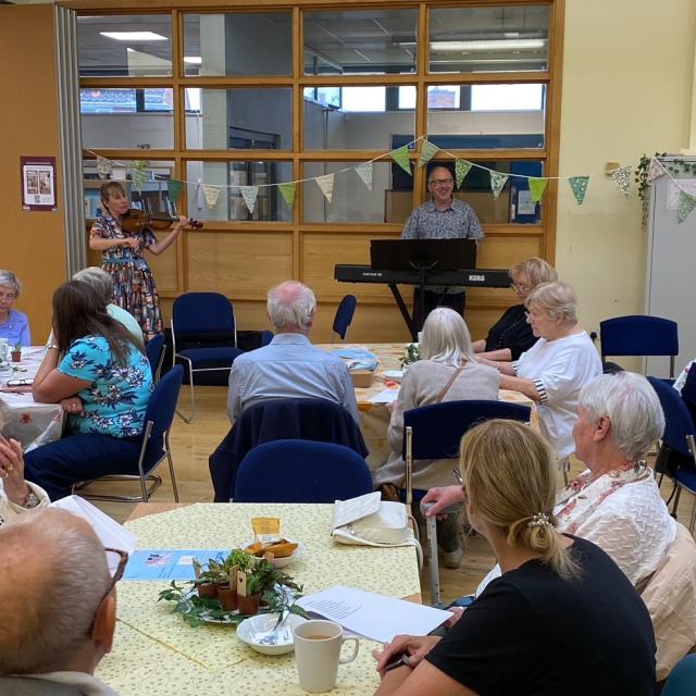 A Know Your Neighbourhood group meets indoors at Barnsley for a garden party.
