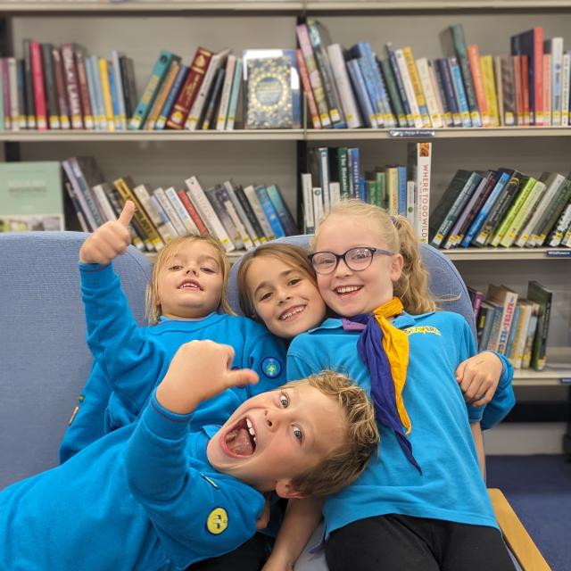 Children enjoy a tour of Godalming library. They are dressed in Scouts and Beavers uniforms.
