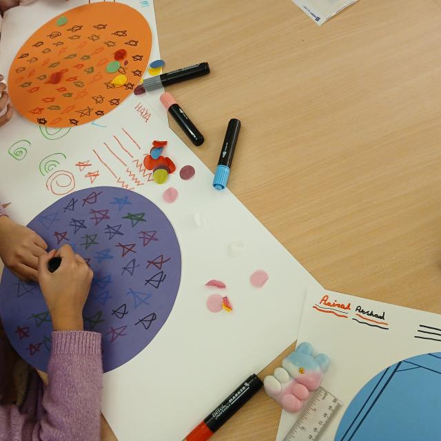 A child is seen practising a craft activity.