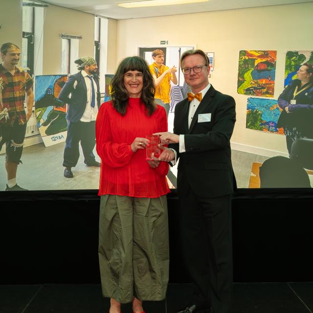 A man presenting a women an award