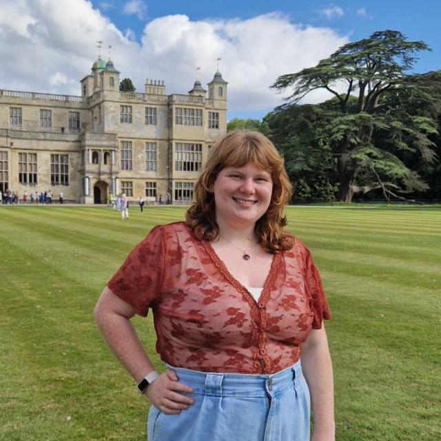 Libraries Connected staff member Lauren O'Kill is photographed in front of a large house.