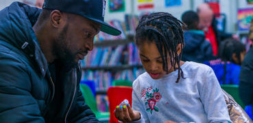Father and child in a library